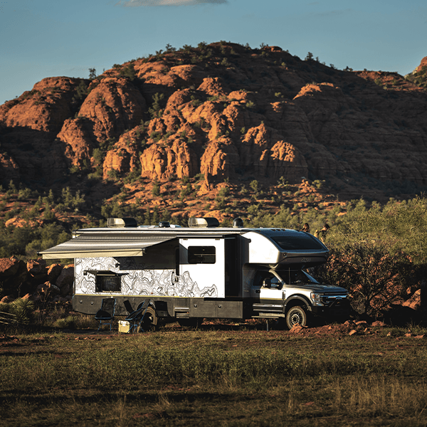 A Jayco Class C motorhome parked against a red-rock desert backdrop