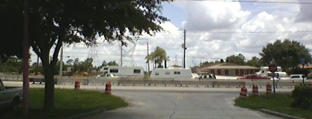 A mini-motorhome towing a travel trailer along a roadside, both relying on separate brake systems