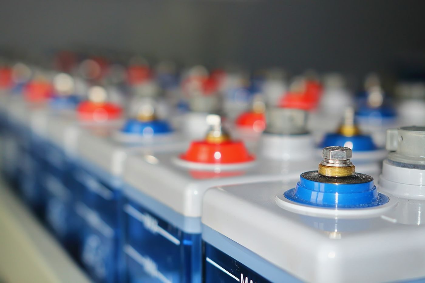 Rows of industrial batteries with red and blue terminal connections