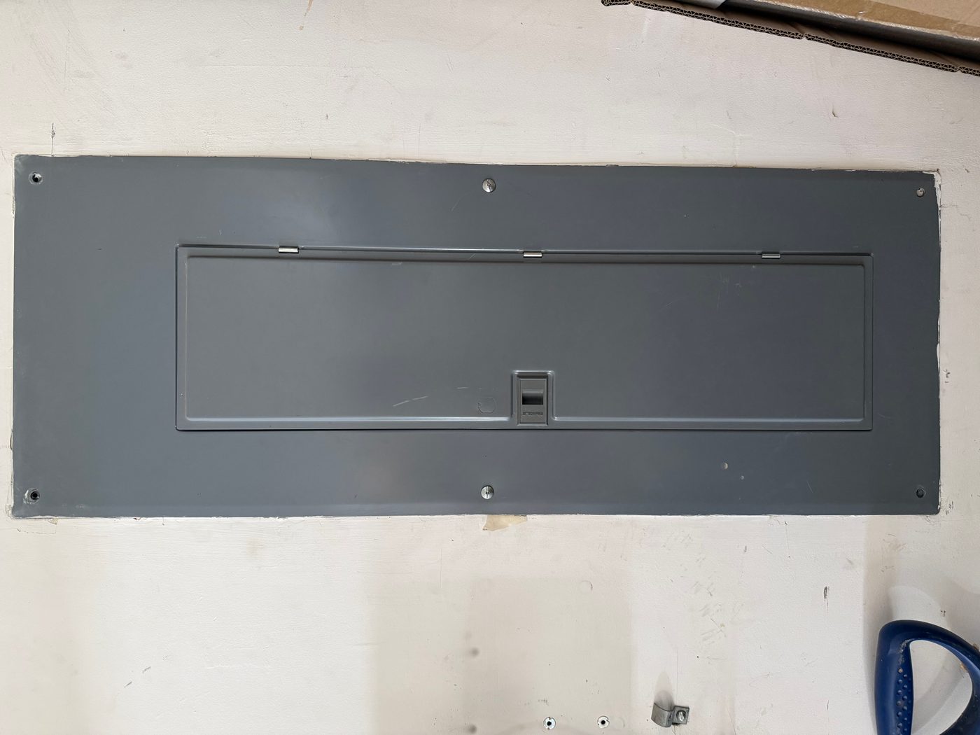 A household circuit breaker panel with rows of breakers