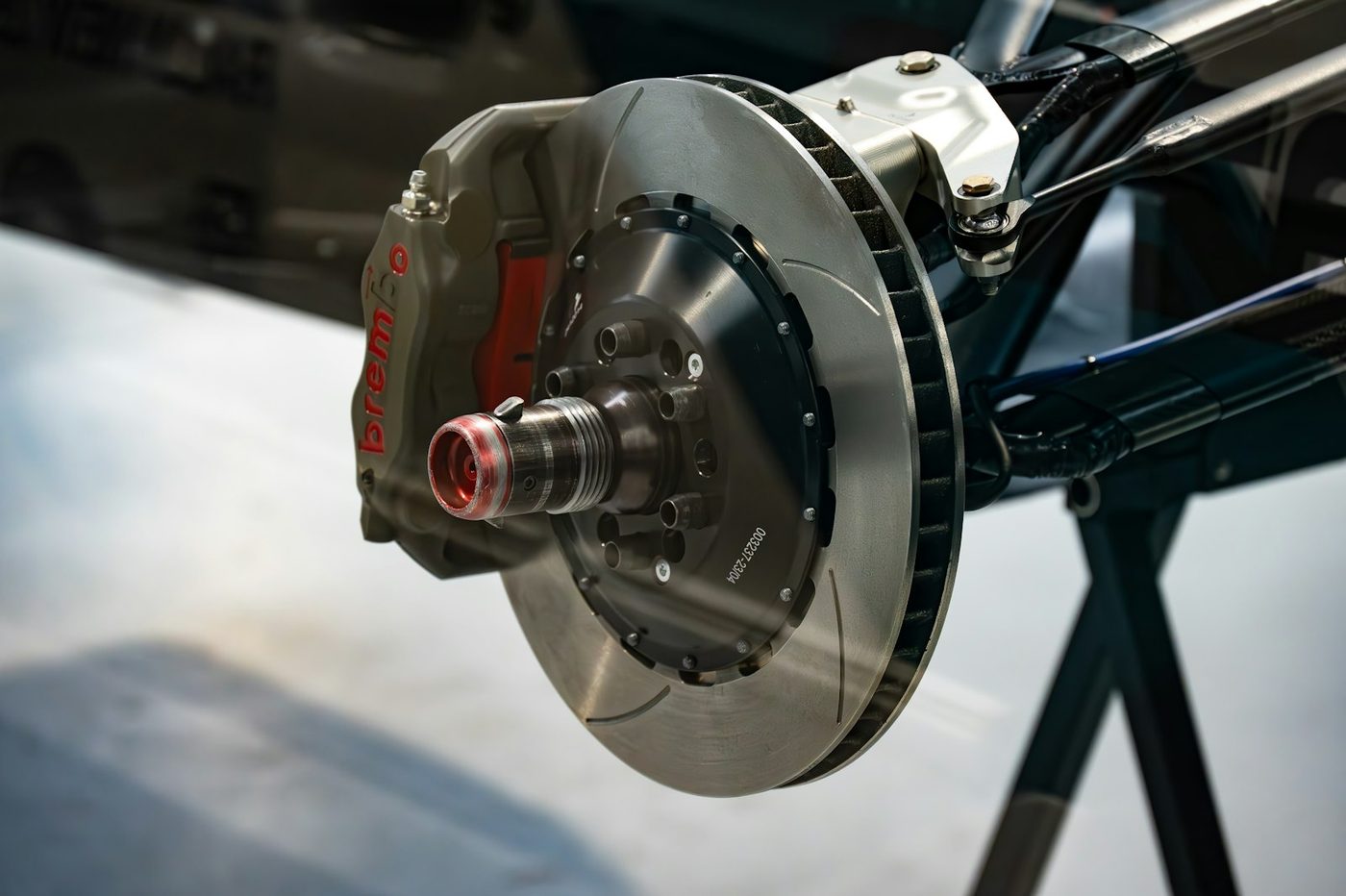 Close-up of a brake rotor, hub, and wheel bolts on a vehicle's front axle