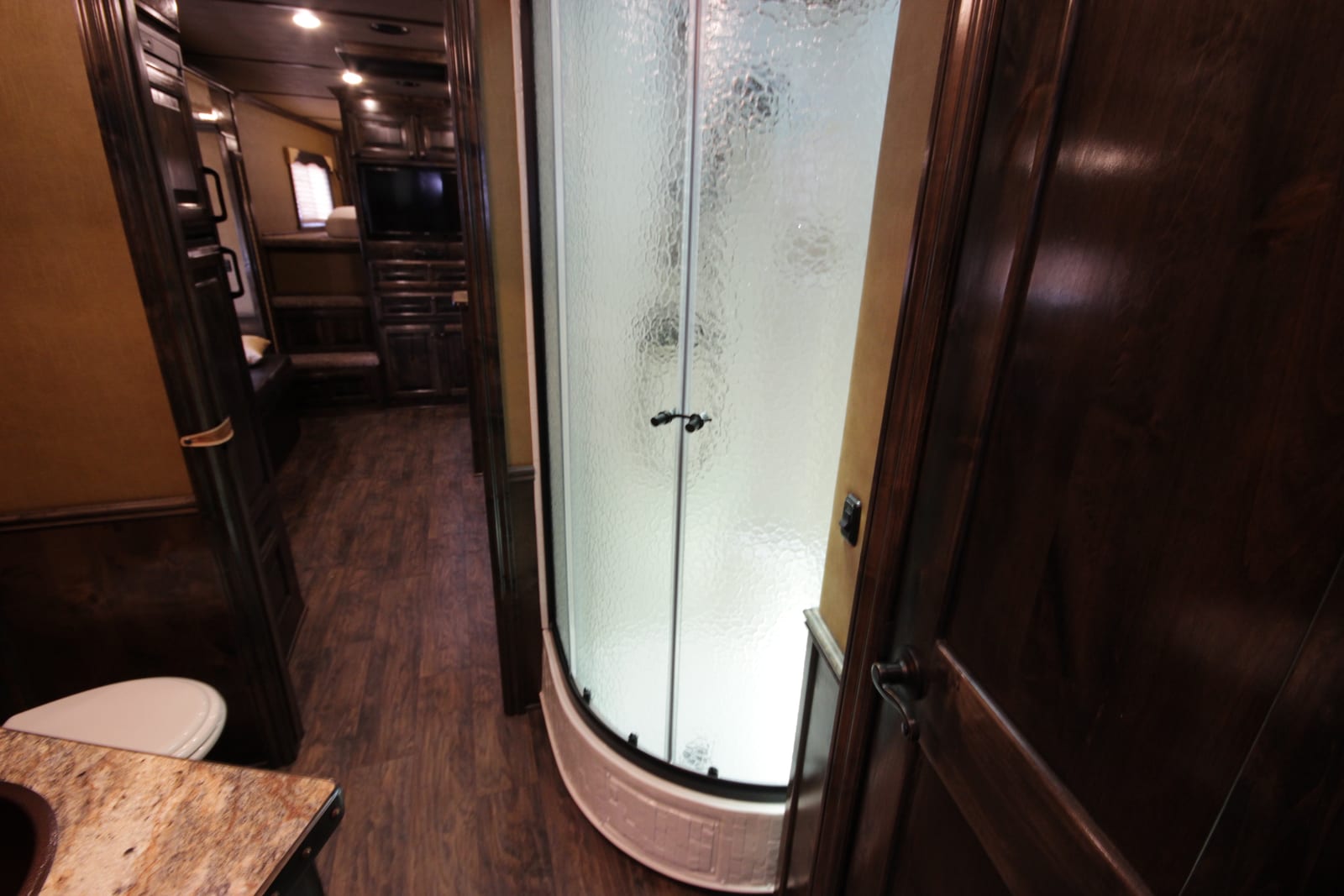 RV interior hallway with a rounded glass shower stall