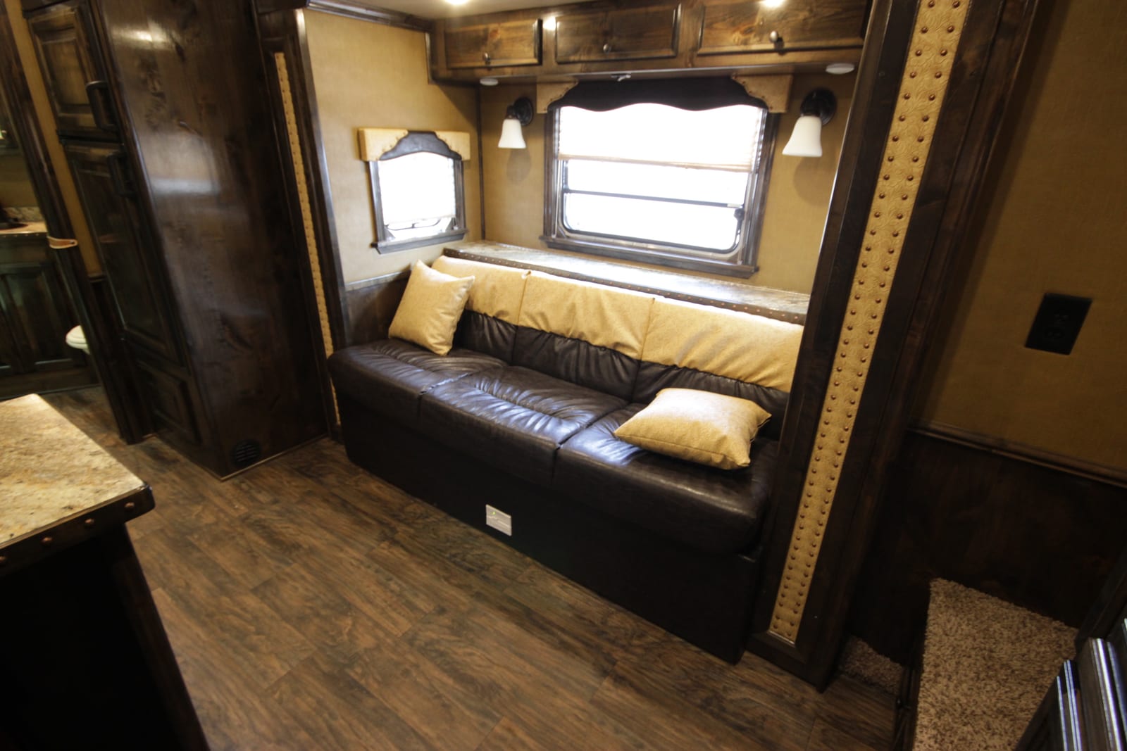A built-in sofa and window nook inside an RV living area