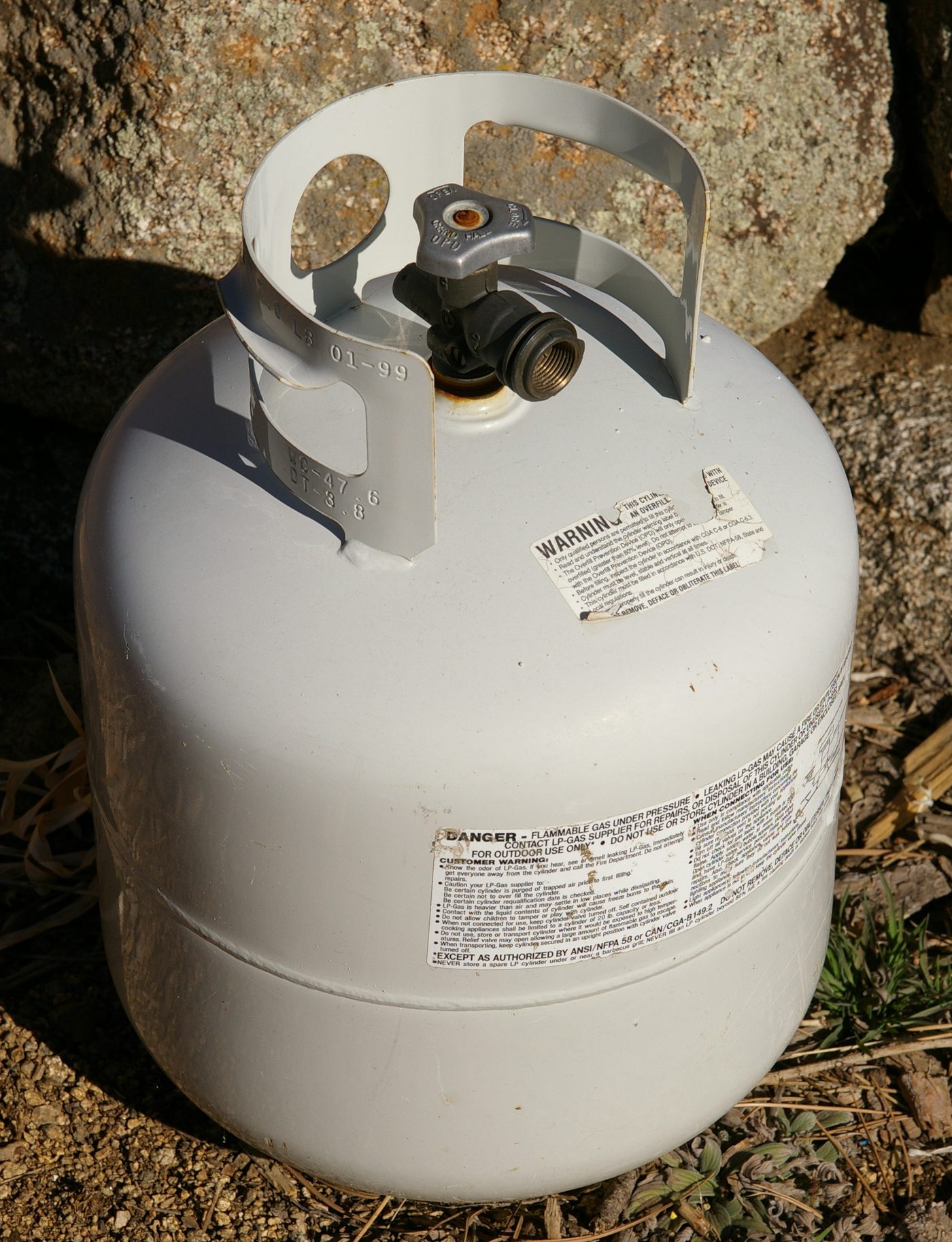A steel 20 lb DOT propane cylinder with an overfill protection device valve