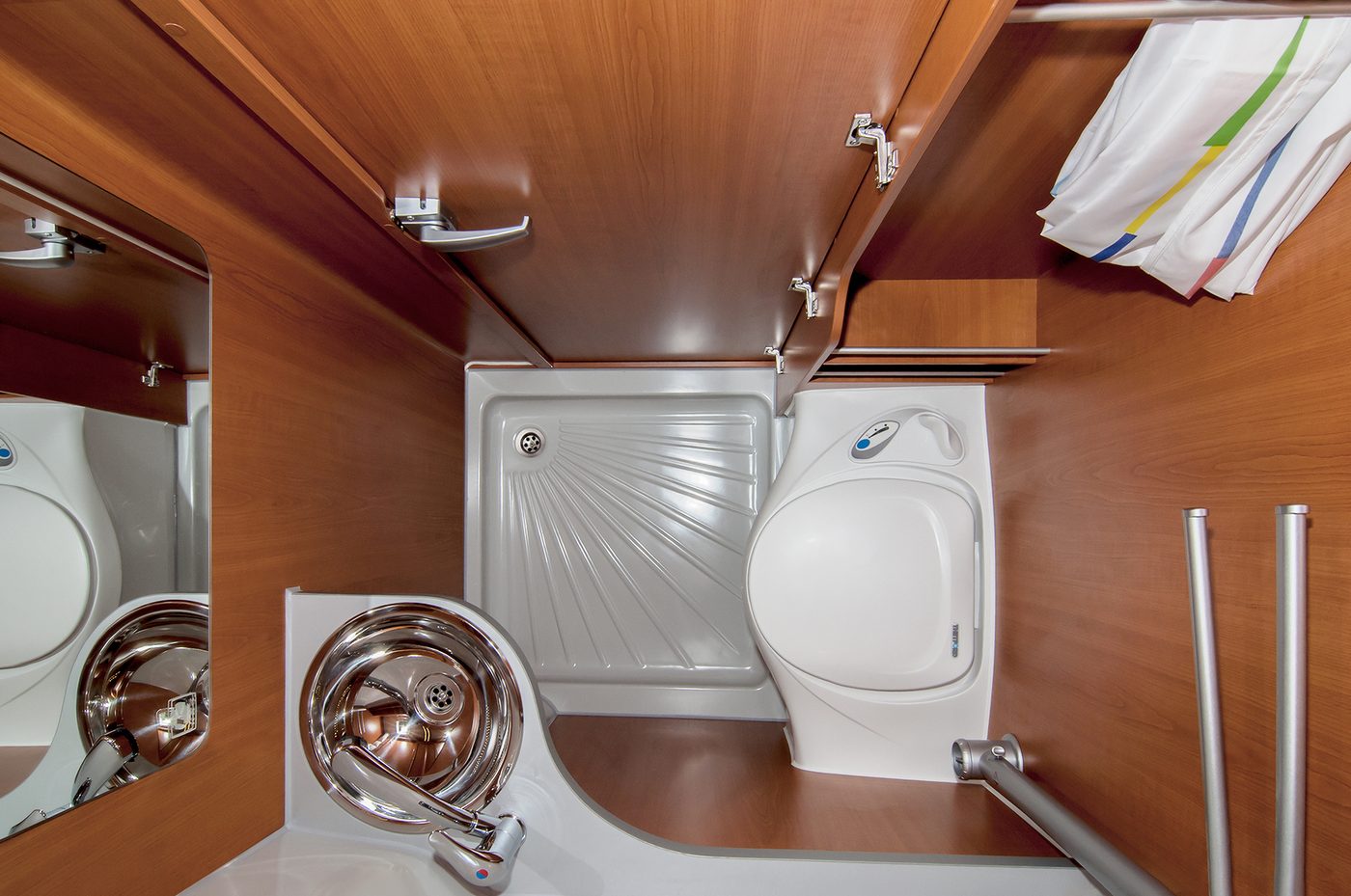 A compact shower cabin with an integrated toilet inside a campervan