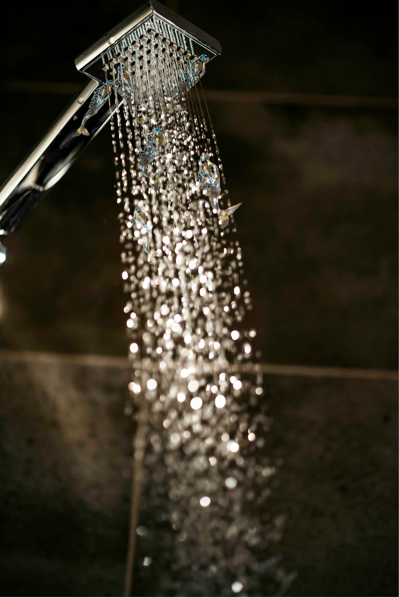 Close-up of a shower head with water flowing