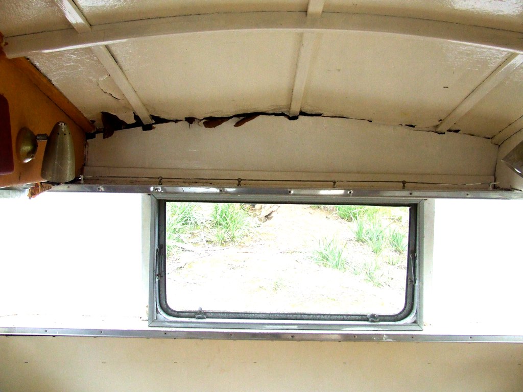 Water damage cracking the interior ceiling panel of an RV near a window
