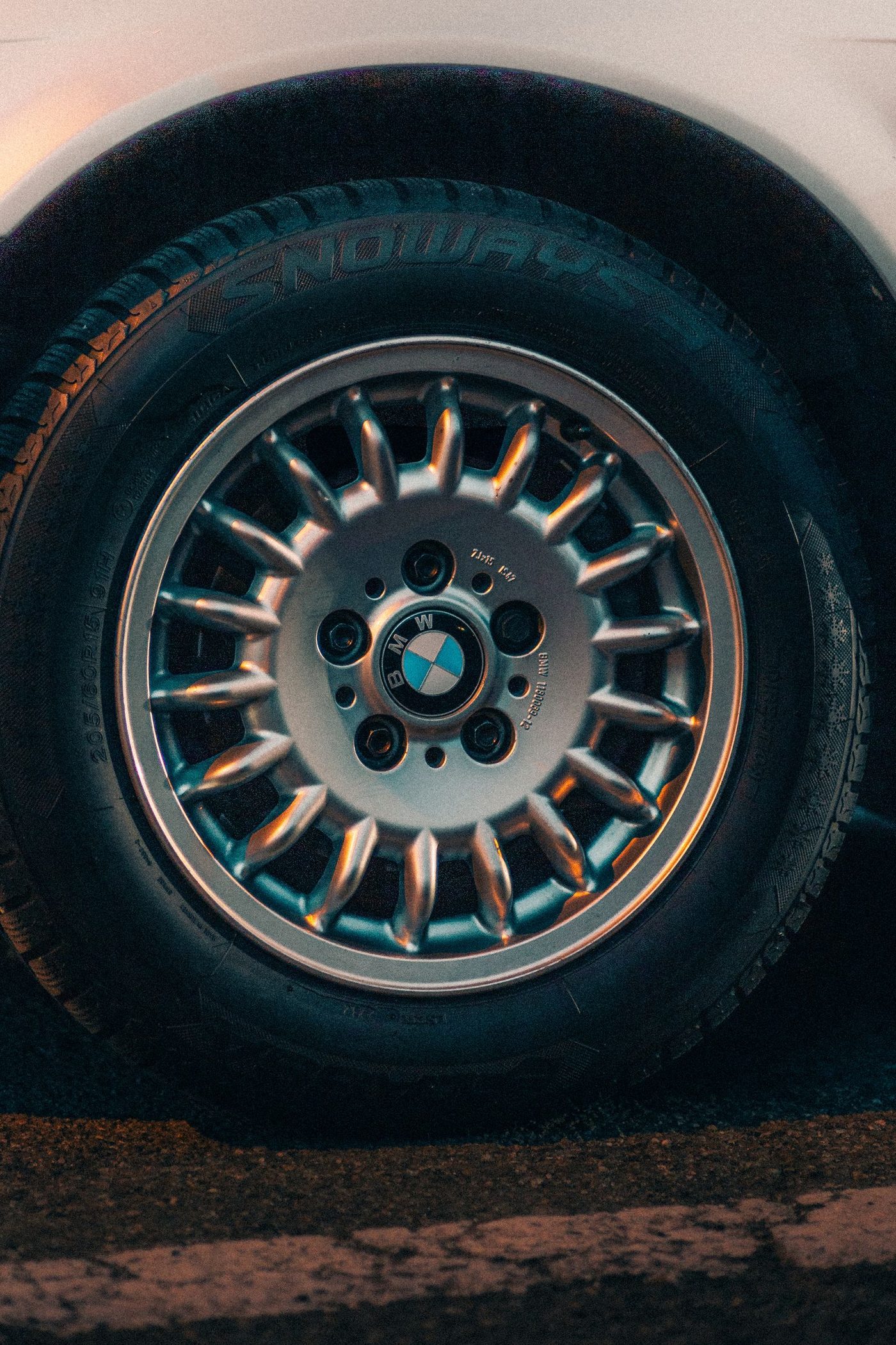 Close-up of a wheel and tire mounted on a vehicle parked on pavement