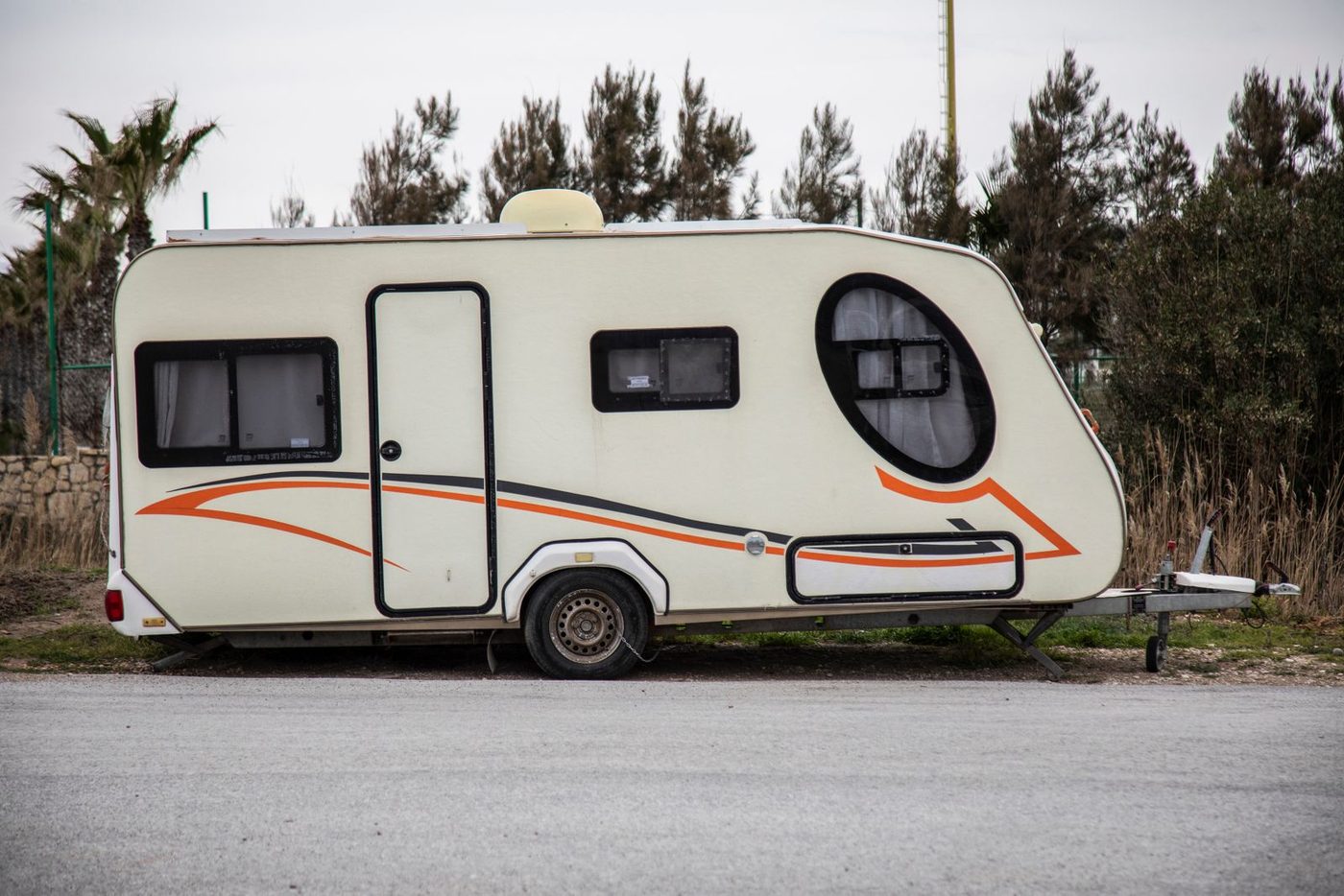 A modern white travel trailer parked outdoors