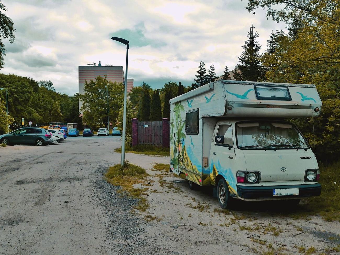 A colorful vintage camper van parked on a city street