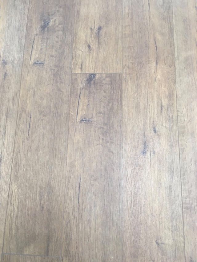 Close-up of wood-look vinyl plank flooring with visible plank seams