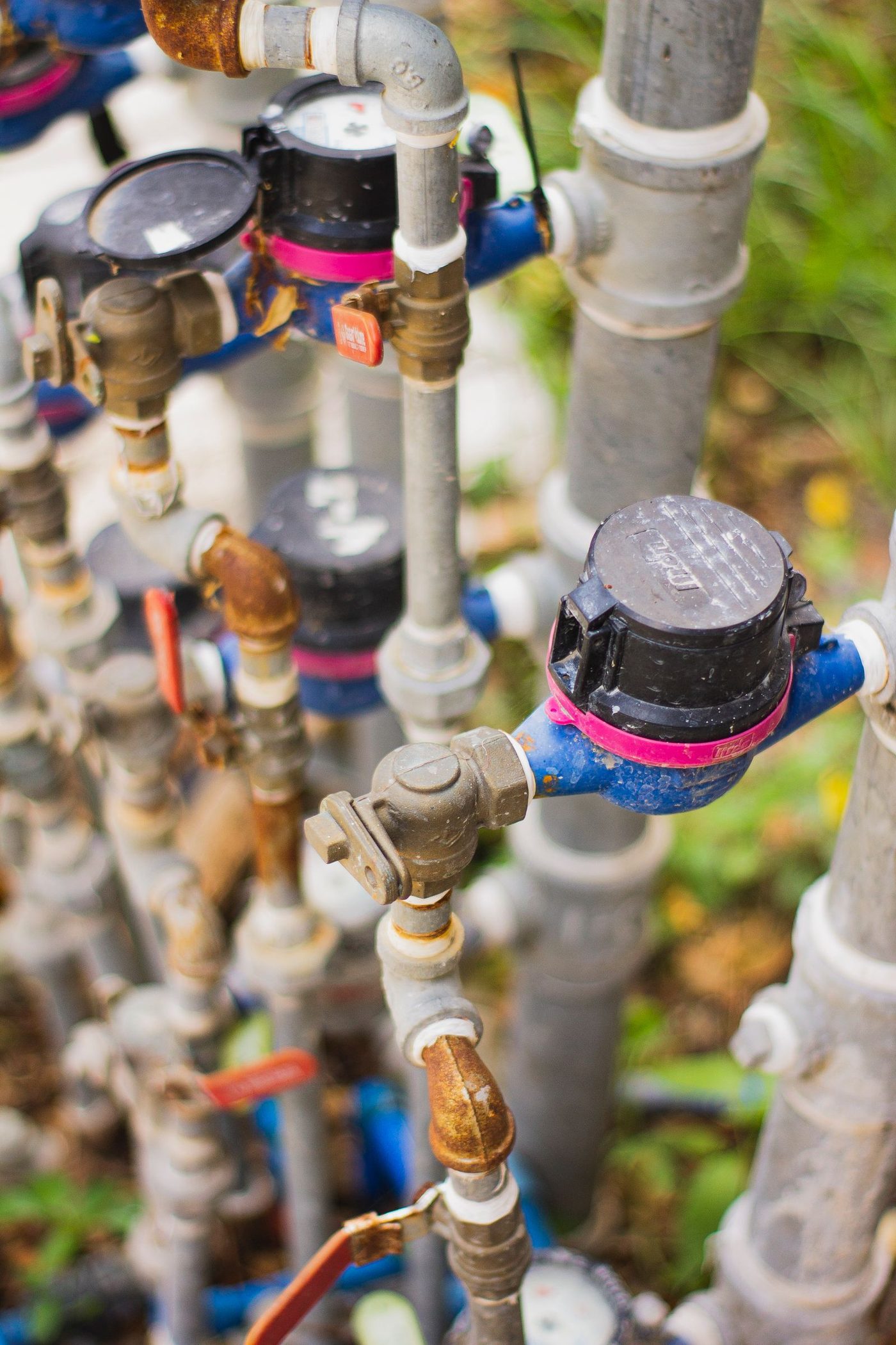 A close-up view of an industrial water system with gauges, valves, and pipes