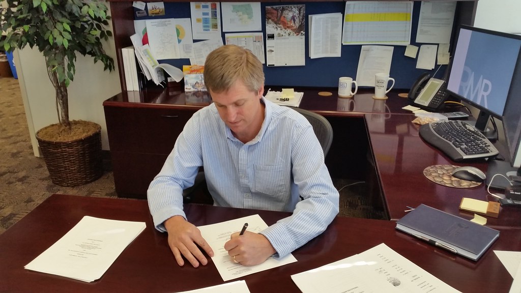 A person reviewing paperwork at a desk, weighing an RV service contract